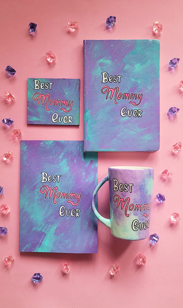 A Hand Painted Gif Set made of a mug, notebook, coaster and card all in pale blue color and having the words "Best Mommy Ever"