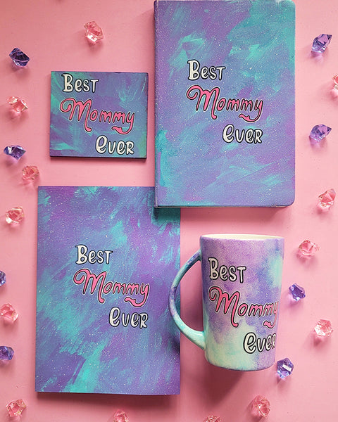 A Hand Painted Gif Set made of a mug, notebook, coaster and card all in pale blue color and having the words "Best Mommy Ever"