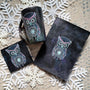 A Black Galaxy hand painted gift set containing a mug, card and coaster all with an owl design