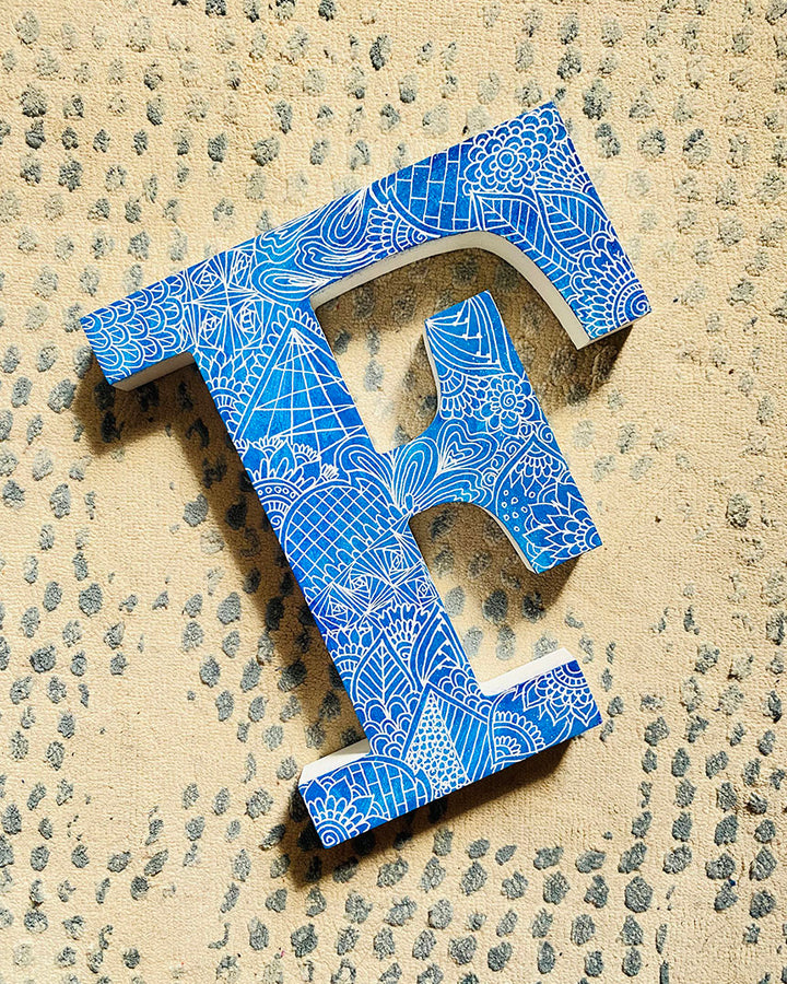 A Blue Galaxy hand painted letter F with doodles in white