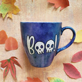 a bluish hand painted mug with the word 