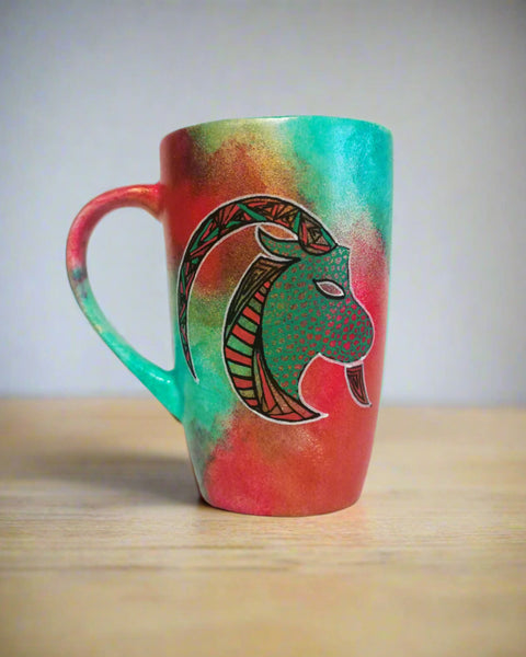 A Hand-painted Christmas color mug with Capricorn sign in black and colored in with green and red