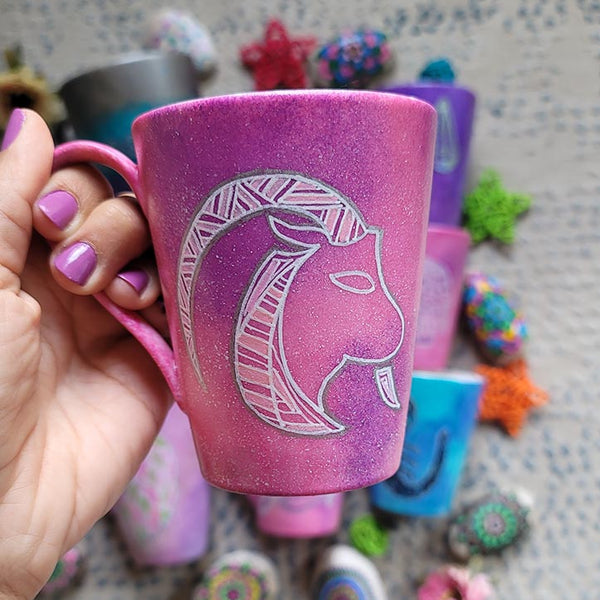 A Hand-painted pink galaxy mug with Capricorn sign in white and patterns in white and pinks