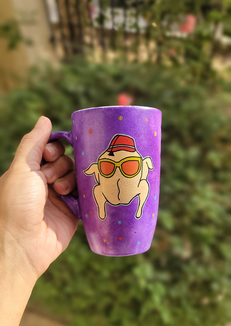 A Purple Hand painted mug with a turkey drawn on it wearing  sun glasses and tarboosh, with red yellow and blue dots scattered all over