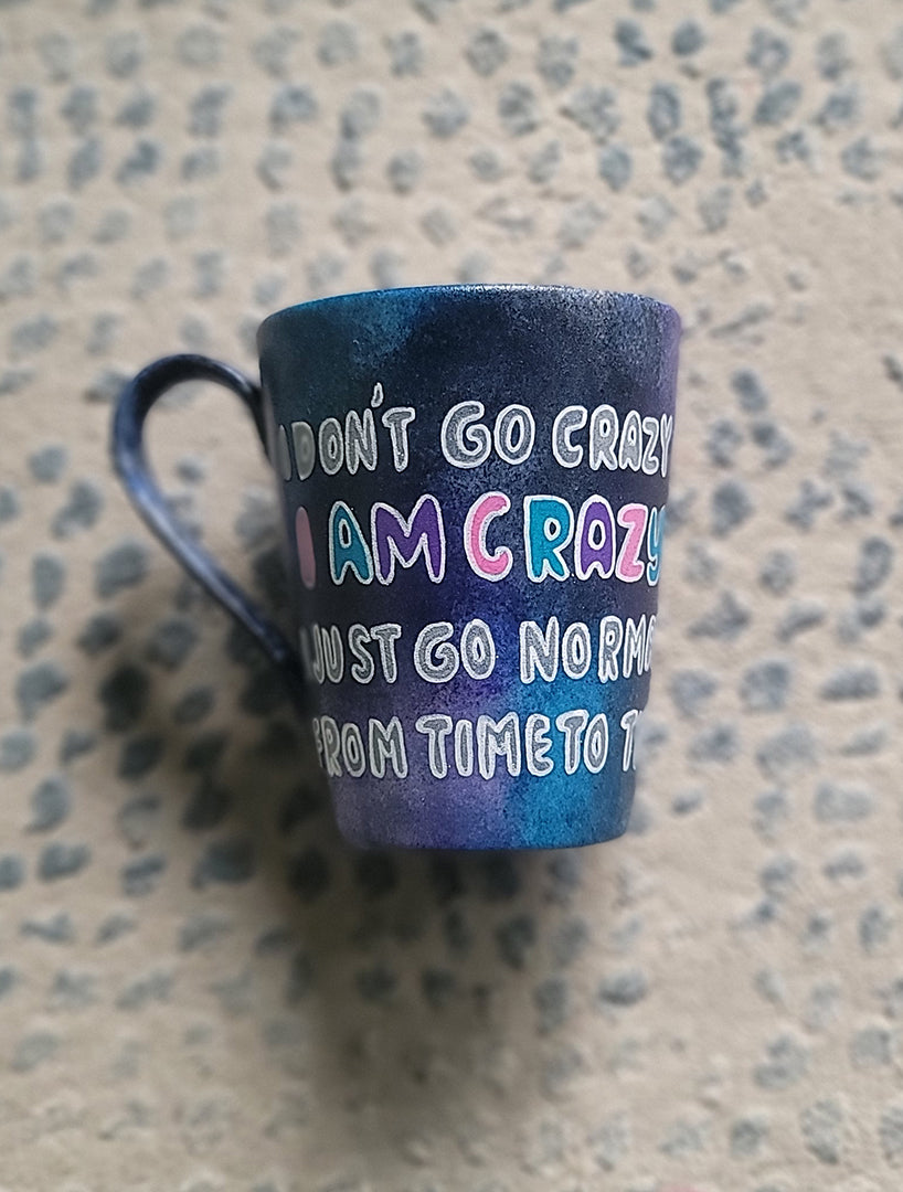 A Black galaxy Hand Painted mug with the words "I Don't go Crazy, I Am Crazy, I just go normal from time to time"