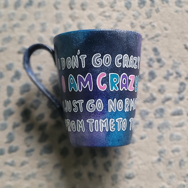 A Black galaxy Hand Painted mug with the words "I Don't go Crazy, I Am Crazy, I just go normal from time to time"