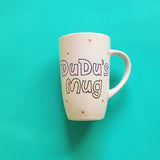 A Pale pink hand painted mug with the sentence 