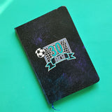 A Black Galaxy Hand Painted Notebook with the drawing of a football net and a football drawn at the corner . The number 30 written in the center of the net and under it the name Aly written