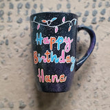 A Black Galaxy hand painted mug with lighting on the top and the words 