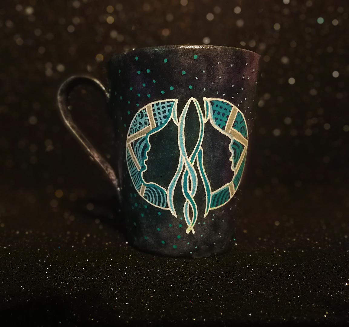 A Hand-painted dark galactic mug with a Gemini sign