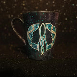 A Hand-painted dark galactic mug with a Gemini sign