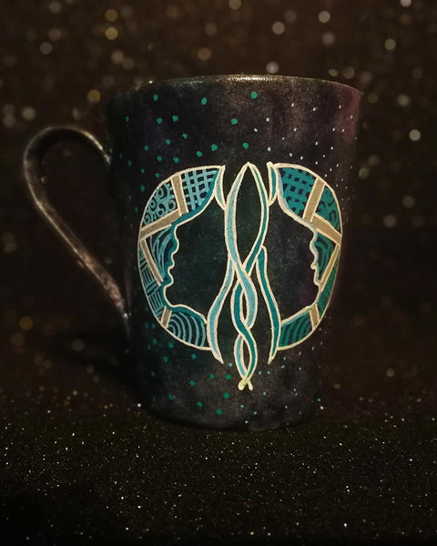 A Hand-painted dark galactic mug with a Gemini sign