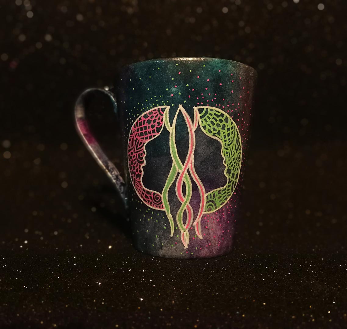 A Hand-painted dark galactic mug with a Gemini sign