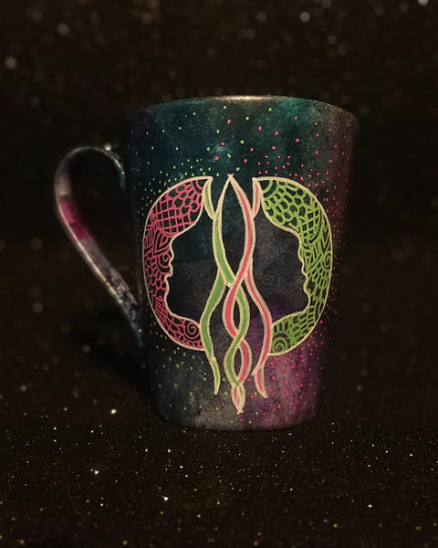 A Hand-painted dark galactic mug with a Gemini sign