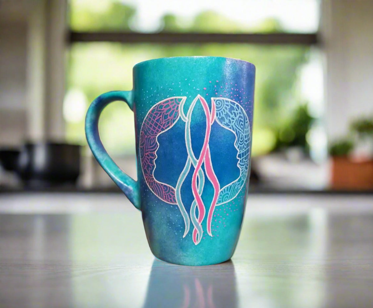 A Hand-painted blue mug with a Gemini sign