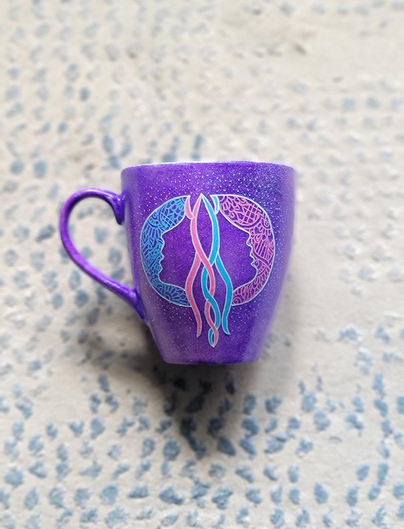 A Hand-painted purple mug with a Gemini sign