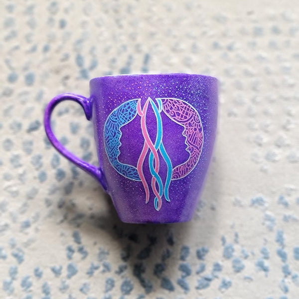 A Hand-painted purple mug with a Gemini sign