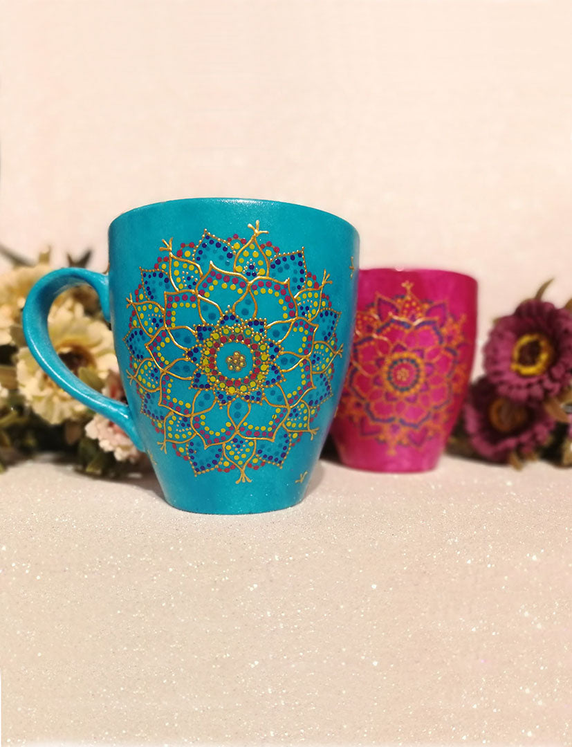 An indian blue hand painted mug with a mandala drawn in relief outliner