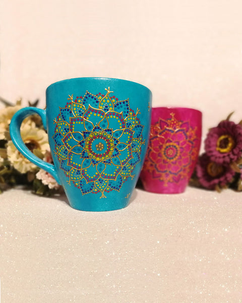 An indian blue hand painted mug with a mandala drawn in relief outliner