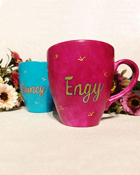 An indian blue hand painted mug with the name Engy