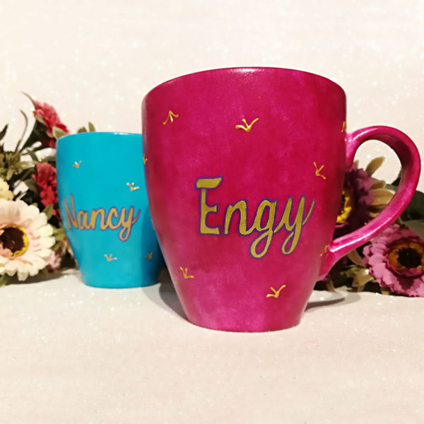 An indian blue hand painted mug with the name Engy