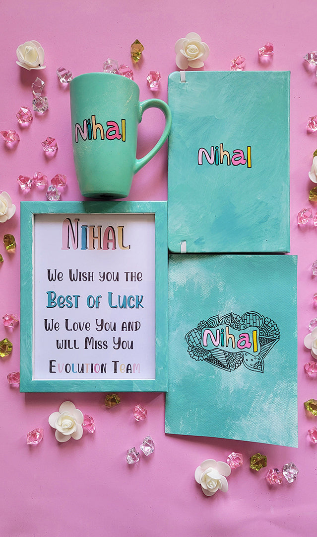 A Gift Set of  a mug, notebook frame and card all hand painted in mint. All with the name Nihal