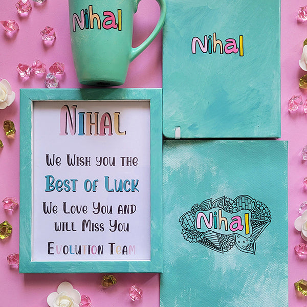 A Gift Set of  a mug, notebook frame and card all hand painted in mint. All with the name Nihal