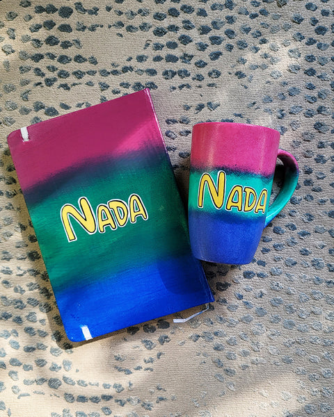 A Gift Set Hand painted in gradient colors (pink-green-blue) containing a mug and notebook with the name Nada written in the center in yellow