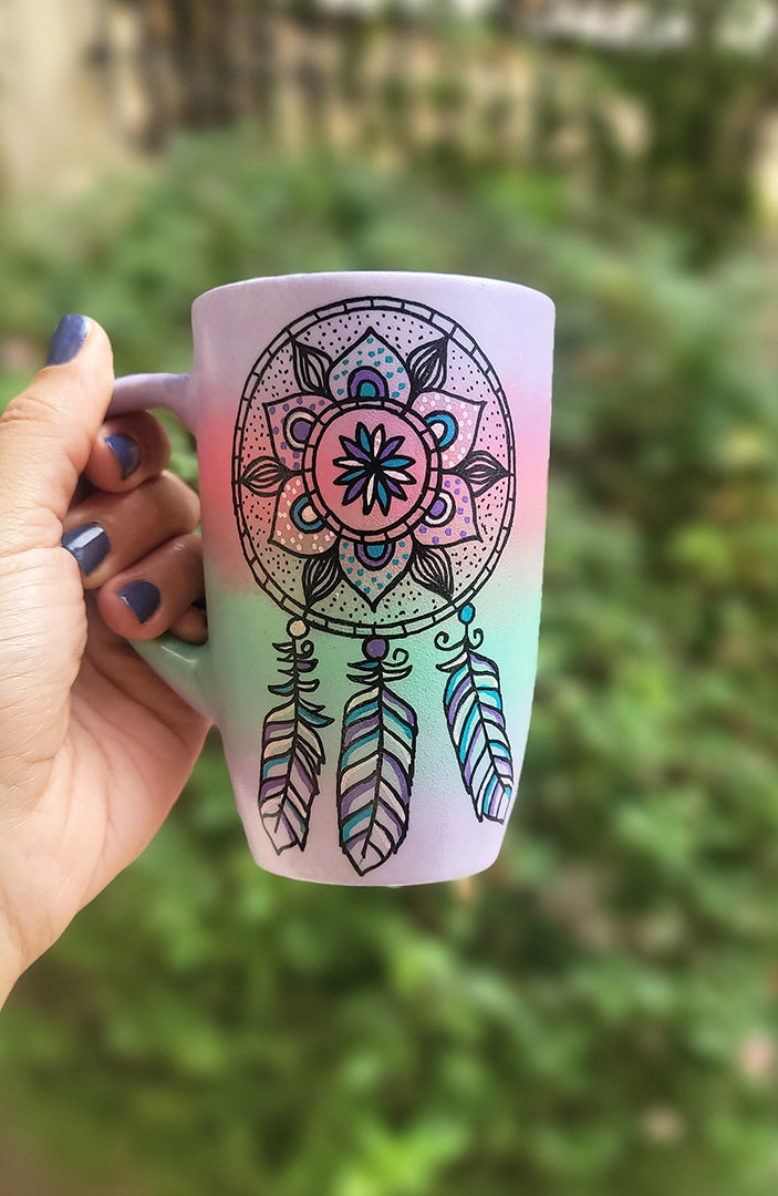 A gradient Hand Painted mug (Lilac, pink mint lilac) with a dreamcatcher in black and colored in purple baby pink and teal