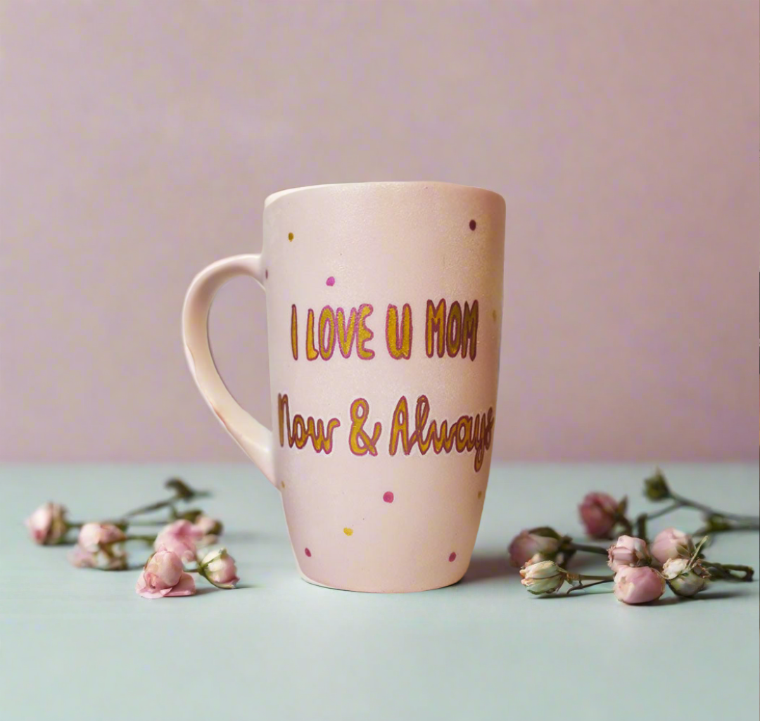 A Pastel Pink Mug with the words "I Love you mom. Now and Always" written in gold outlined by dark pink