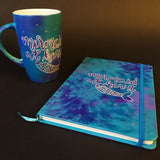 A Gift Set of a a mug and matching notebook all hand painted in blue and have the sentence 