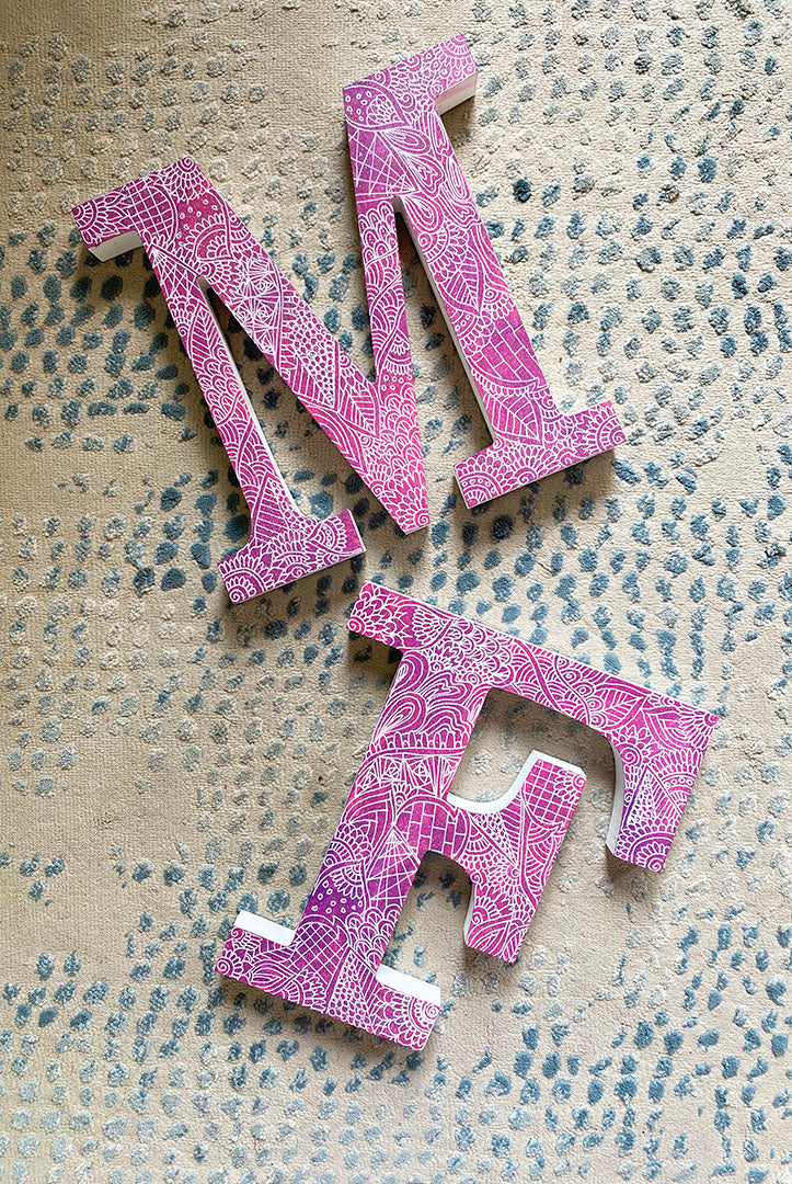 A Pink Galaxy hand painted letter F and M with doodles in white