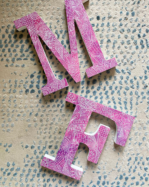 A Pink Galaxy hand painted letter F and M with doodles in white