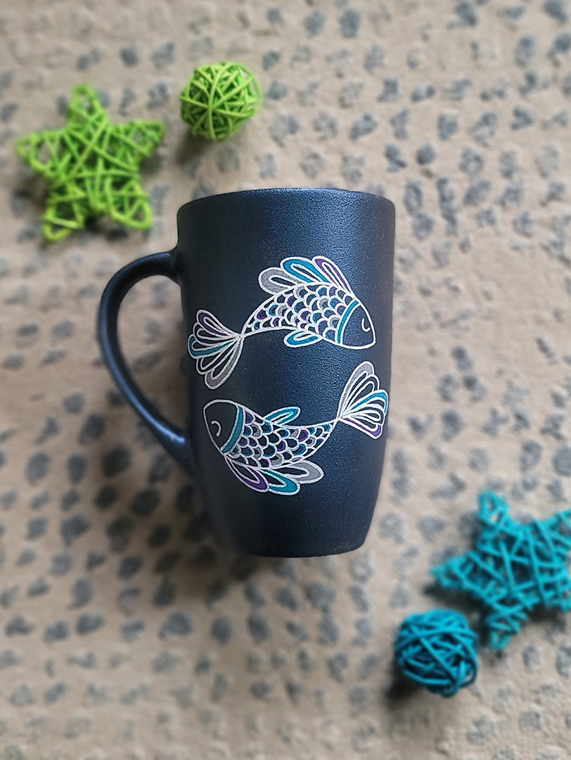 A Handpainted Shimmery blue  mug with a Pisces design on it