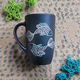 A Handpainted Shimmery blue  mug with a Pisces design on it