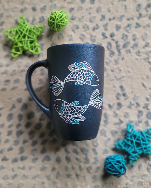 A Handpainted Shimmery blue  mug with a Pisces design on it