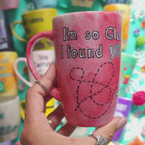 A hand-painted red galaxy mug with the words 