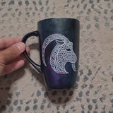 A Video showing a hand-painted  dark galactic colored mug with capricorn on one side and the words 