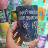 A hand painted black galaxy mug with the words 