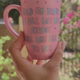 A hand-painted shimmery pink mug with the words 