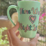  A Hand painted green Mug with the words 