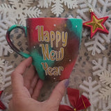 A Christmas hand painted mug with the words 