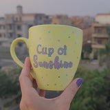 A Pastel yellow hand painted mug with the words 