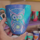 A Blue galaxy hand painted mug with an owl in zentangles drawn on it and the other side has the name 