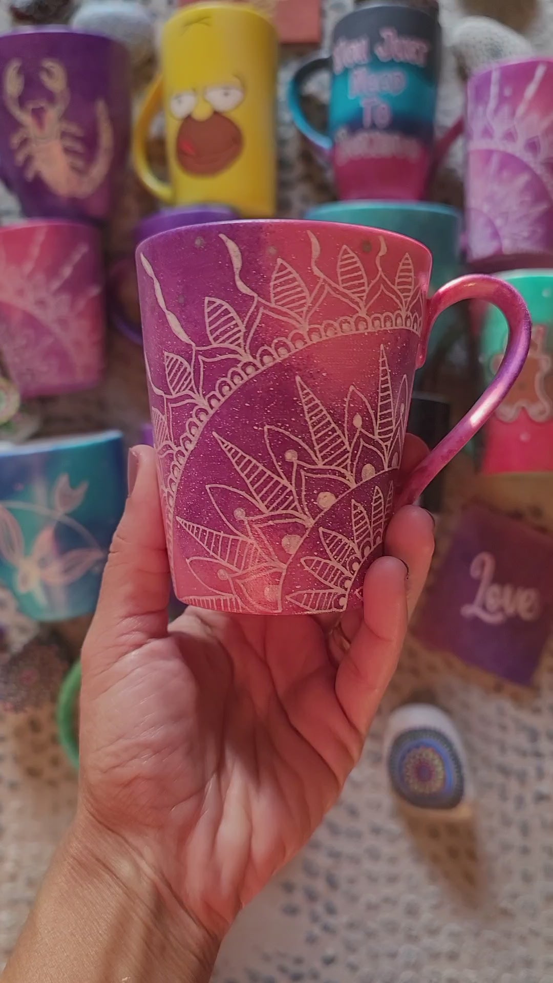 A hand-painted pink galaxy mug with a quarter mandala drawn in the corner and the word forever on the other side in silver and white outline