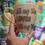 A hand-painted goldish mug with the words 