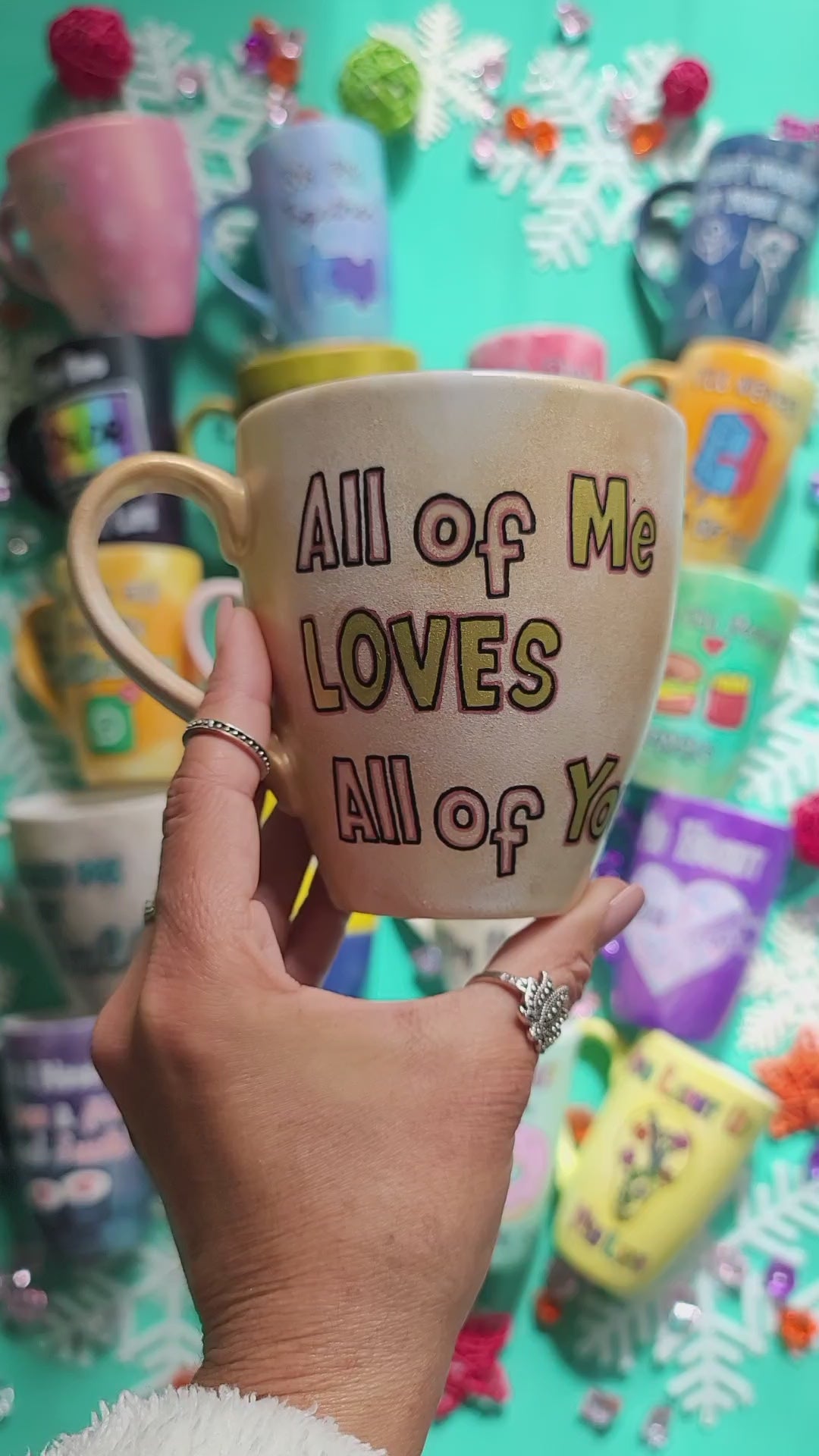 A hand-painted goldish mug with the words "all of me" on one side and the name "Jomana " on the other