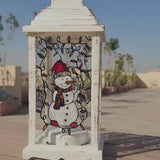 A White Vintage Lantern with 4 hand painted glass sides.  the first with a snowman, the second with the name 