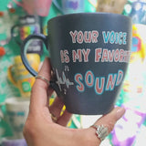 A shimmery blue hand painted mug with the sentence 