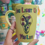 A Pastel yellow hand-painted mug with the words 